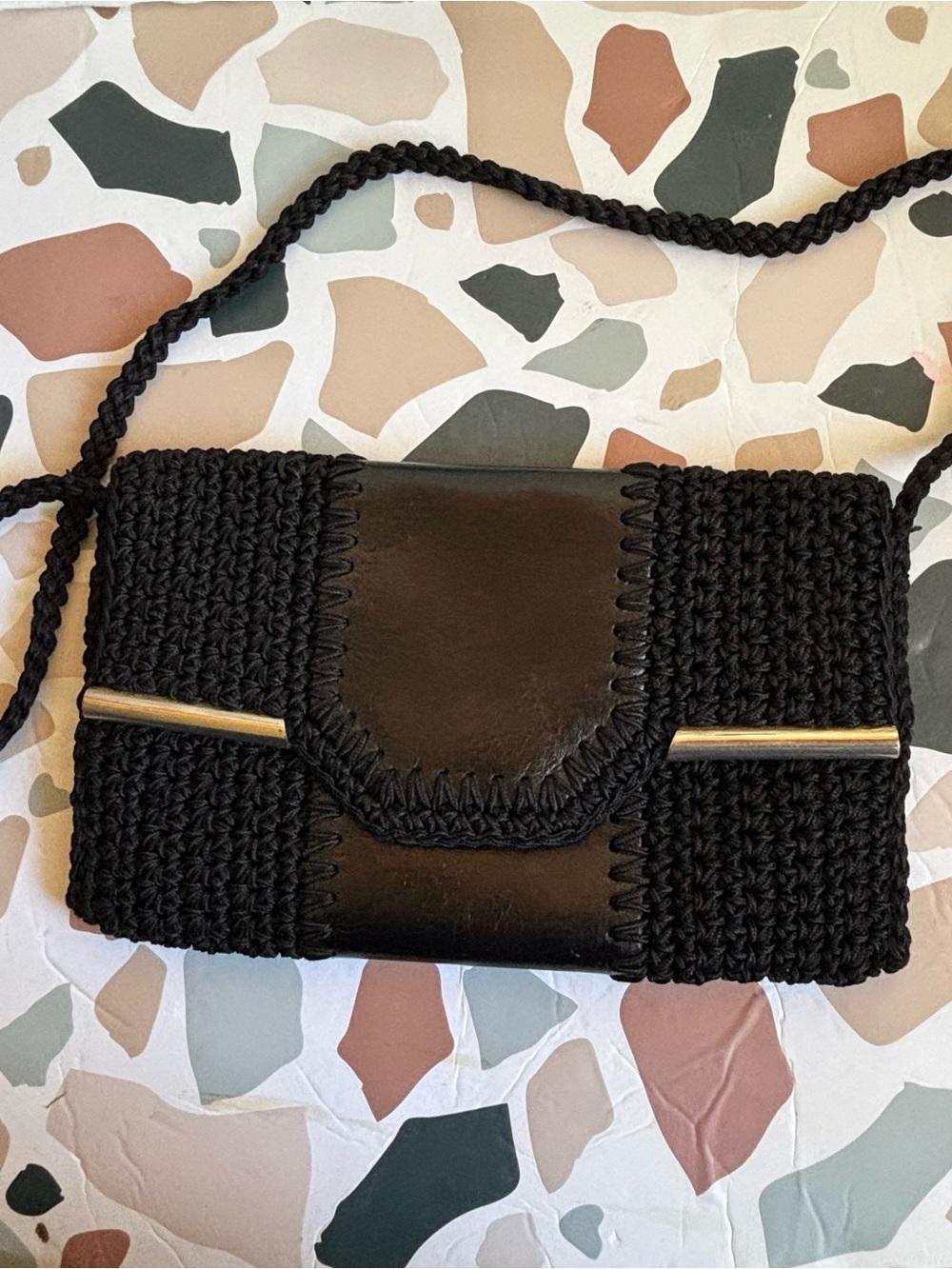 black cord woven fold over leather clutch shoulder back snap on closure